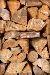 pile of chopped fire wood stacked against a wall