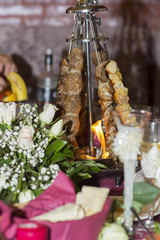 Wedding dinner in the restaurant. Meat kebab on the holiday table.