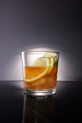 whisky on the rocks, and lemon slices