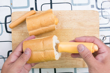 Chef put sausage to bread