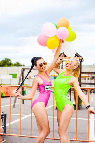Two Beautiful Cute Sexy Hipster Girls In Pink And Light Green Bikini