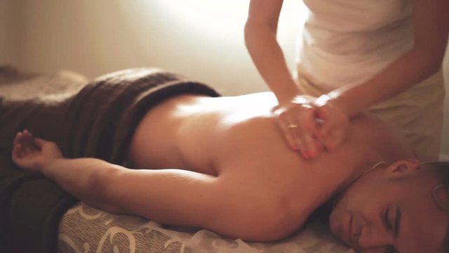 Man receiving healthy massage in spa salon