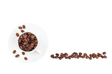 coffee beans in a line next to a white cup filled with coffee beans, isolated on white, CLIPPING PATH INCLUDED