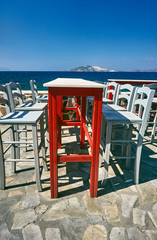 Table and chairs Greek taverna on the seafront on the island of Nisiros.