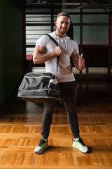 Fototapeta na wymiar Young man with sports bag