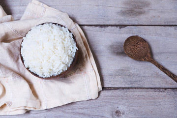 Top view of cooked rice in a wooden bowl.