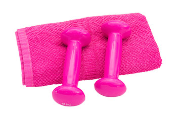 Two pink dumbbells and a soft towel