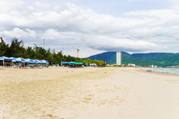 Palm shelters and people on China Beach in Danang
