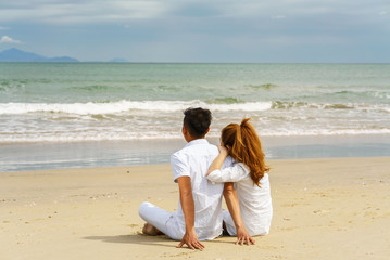Young couple sitting and looking at the sea in Danang