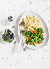 Pasta with broccoli. Delicious healthy vegetarian lunch. On a light background