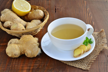 Ginger tea with lemon on a wooden table