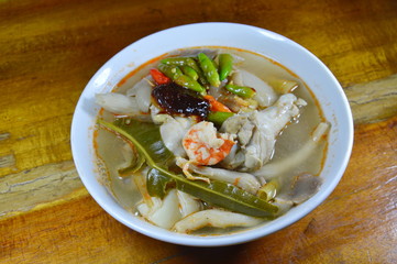 boiled seafood with chicken leg spicy soup topping chili on bowl