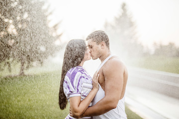 young couple in love having fun and enjoying the beautiful nature.Young couple in the rain