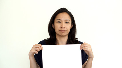 South East Asian girl casually holding while sign for copy space