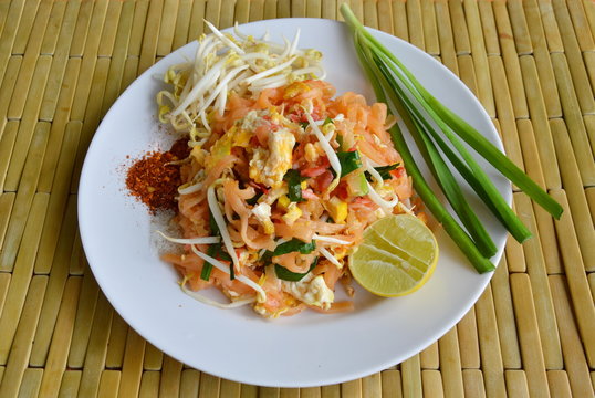 Pad Thai stir fried rice noodle with egg and vegetable on plate