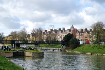 A view of Chesterton Road and the lock, weir and pedestrian footbridge near Jesus Green in Cambridge, UK.