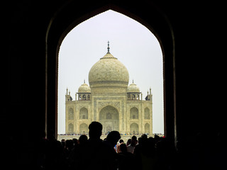 perspective view on Taj-Mahal mausoleum with reflection in water.