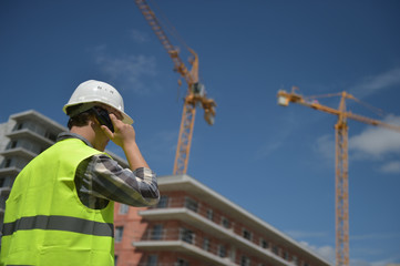 Foreman using walkie-talkie on construction site