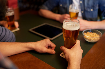 close up of men drinking beer at bar or pub