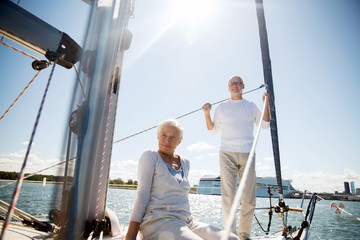 senior couple hugging on sail boat or yacht in sea