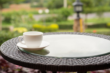 Coffee espresso on wood table nature background in garden,warm tone