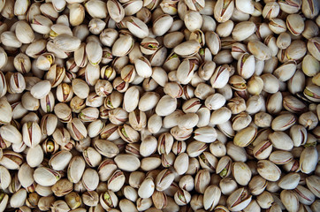 Mound of white pistachios in open shells close-up
