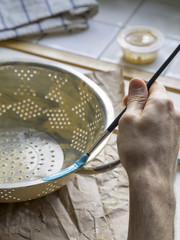 painting a recycled pot