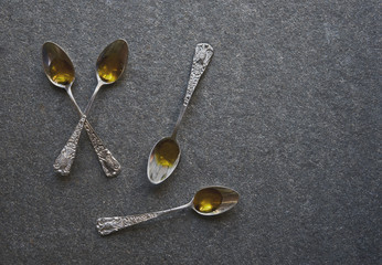 Olive oil in vintage spoons