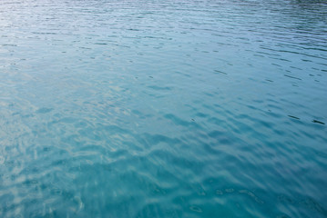 ripples on the water surface with reflection of sky