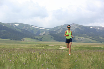 healthy lifestyle young fitness woman runner running on grassland
