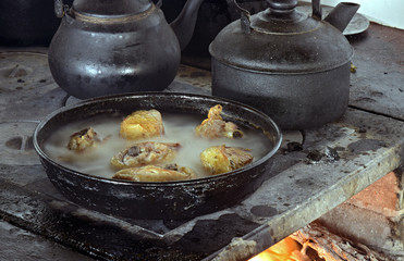 Chicken frying on wood stove