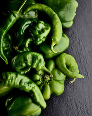 Fresh green pepper and basil on a dark background
