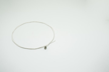 The guitar string on the white background.