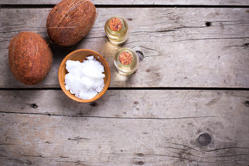 Obraz na płótnie Canvas Coconuts and coconut oil on vintage wooden background.