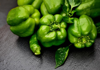 Fresh green bell  pepper on a dark background