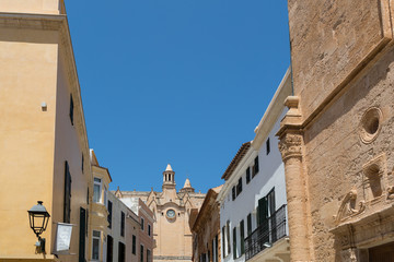 Fototapeta na wymiar Stone houses with church and clock under the blue sky
