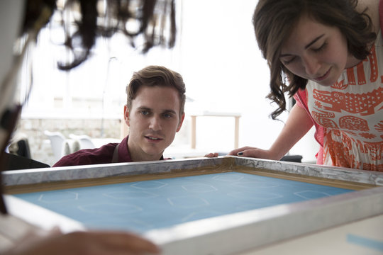 Two People Working In Screen Printing Business