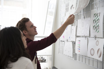 Team Working In Screen Printers Looking At Visual References
