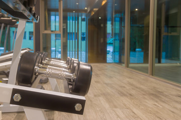 weight body building with Sports dumbbles,Dumbbells in the fitness room.