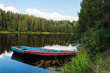 Old wooden boat on the river in Karelia