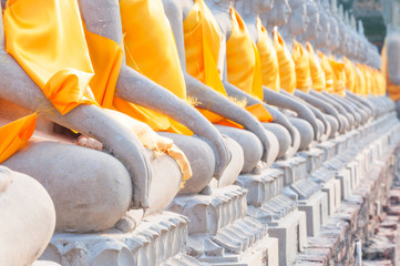 Buddha statues in at Wat Yai Chaimongkol in Ayutthaya Thailand, in Ayutthaya historical park, which is recognized as a unesco world heritage site - obrazy, fototapety, plakaty