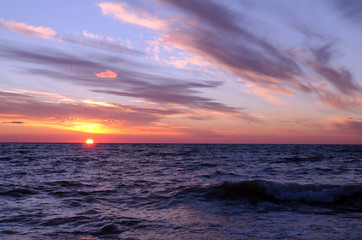 sunset over ocean in summer