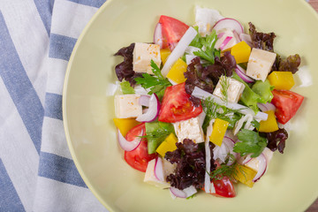 Appetising fresh Greek salad with feta cheese, fresh vegetables