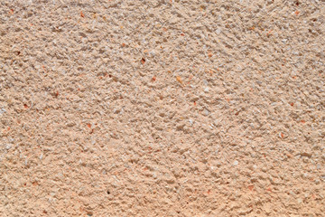 texture of a concrete wall decorated with small stones