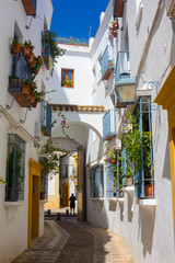 Fototapeta na wymiar Streets decorated with bows and barred windows typical of the city of cordoba spain