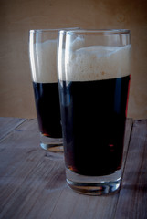 Glasses with kvass - flavored drink, reminiscent in taste non-alcoholic beer. On a wooden background.