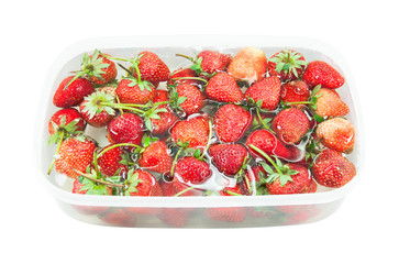 red freshly Strawberry inside cold water, sweet spring strawberries closeup, on white background