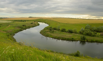 Fototapeta na wymiar Cloudy summer landscape with river