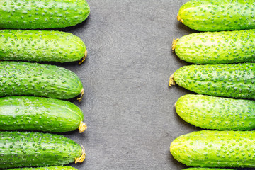 Cucumbers on a black wooden background 