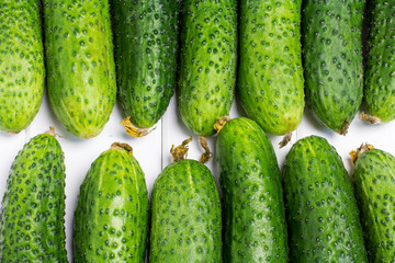 Cucumbers on a white wooden background 